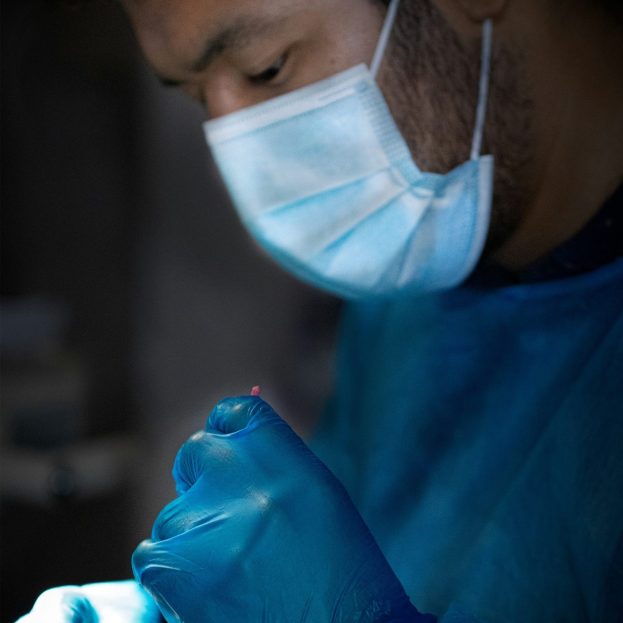 photo closeup of a dentist inspecting a patient