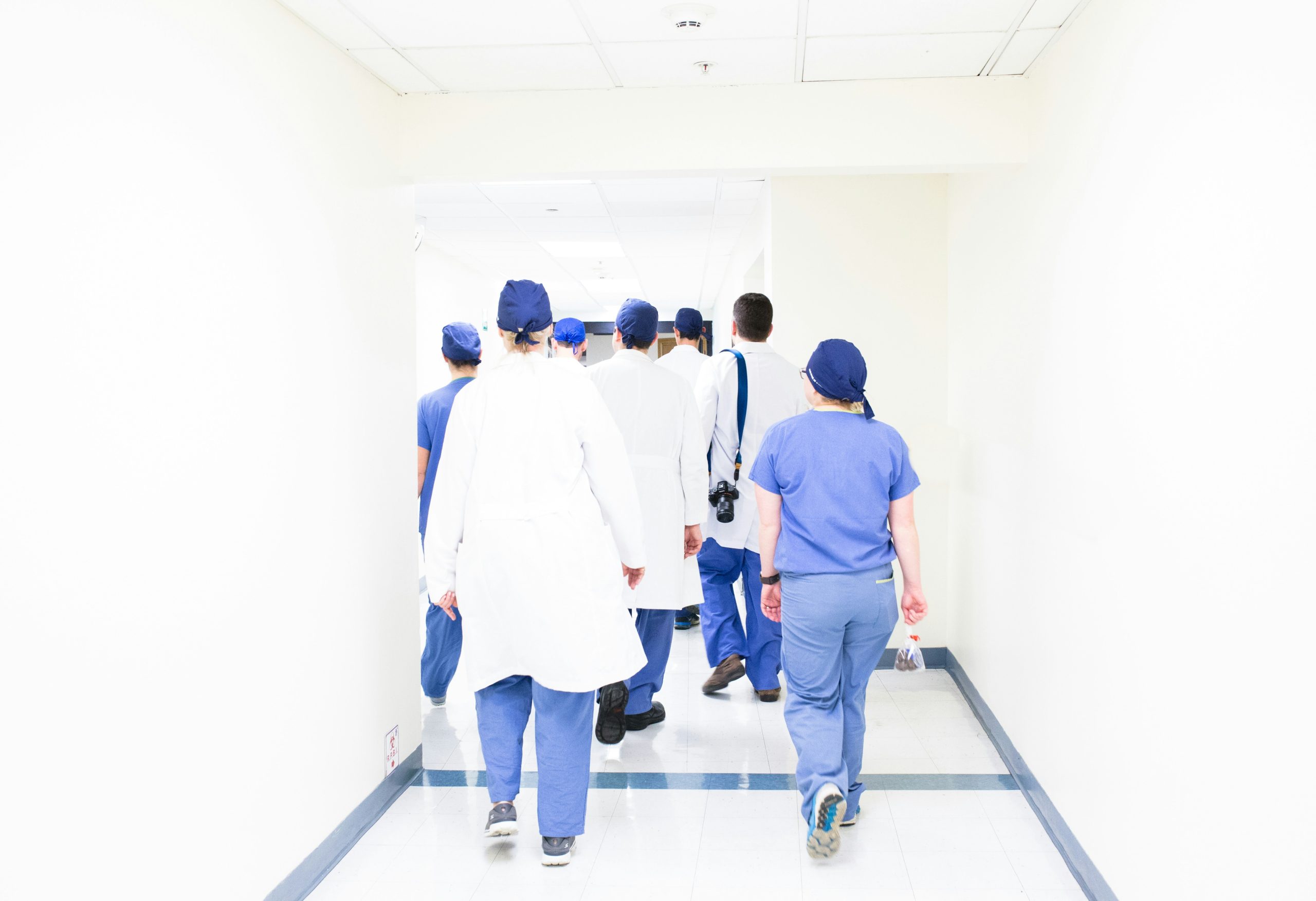 Group of healthcare professionals walking down the corridor together