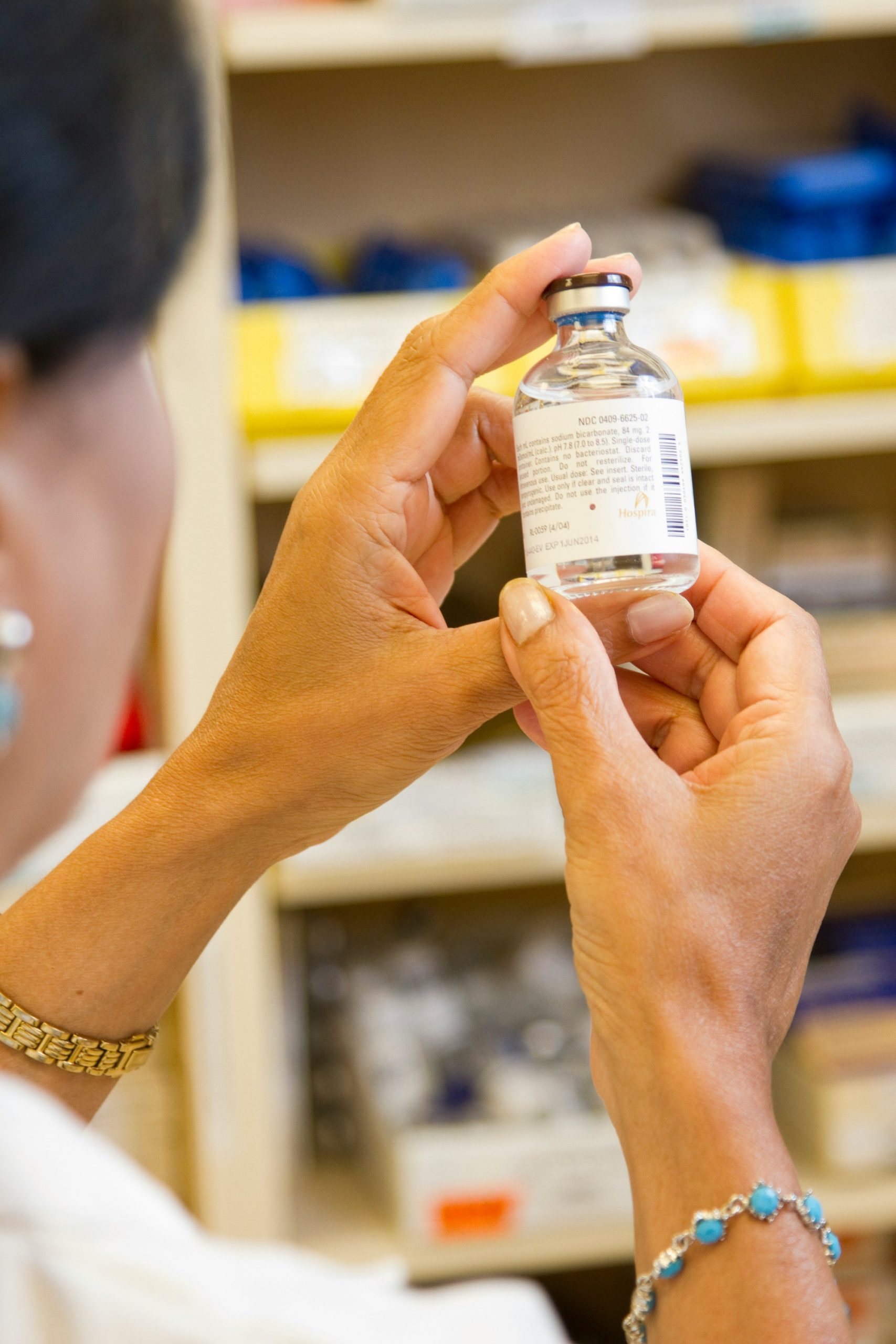 photo of a medical professional holding a vial of medicine