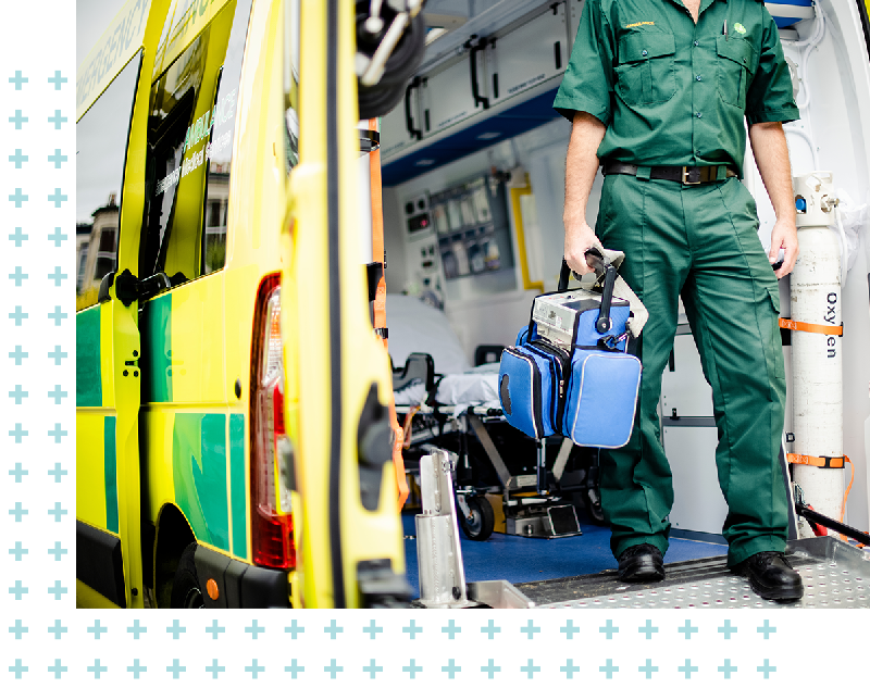 Paramedic exiting the ambulance with medical equipment