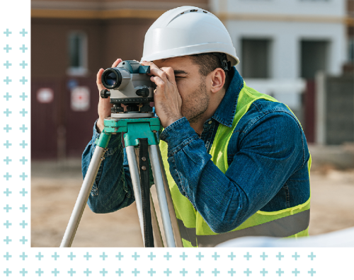 photo of a man using survey equipment