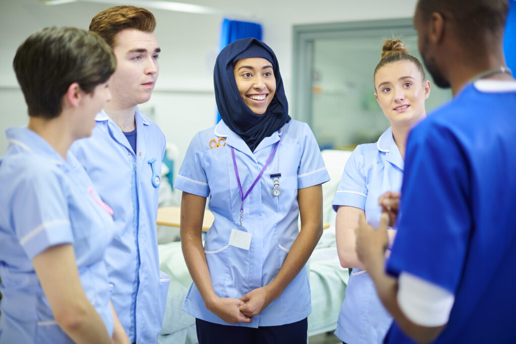 An image of nurses having a team meeting together